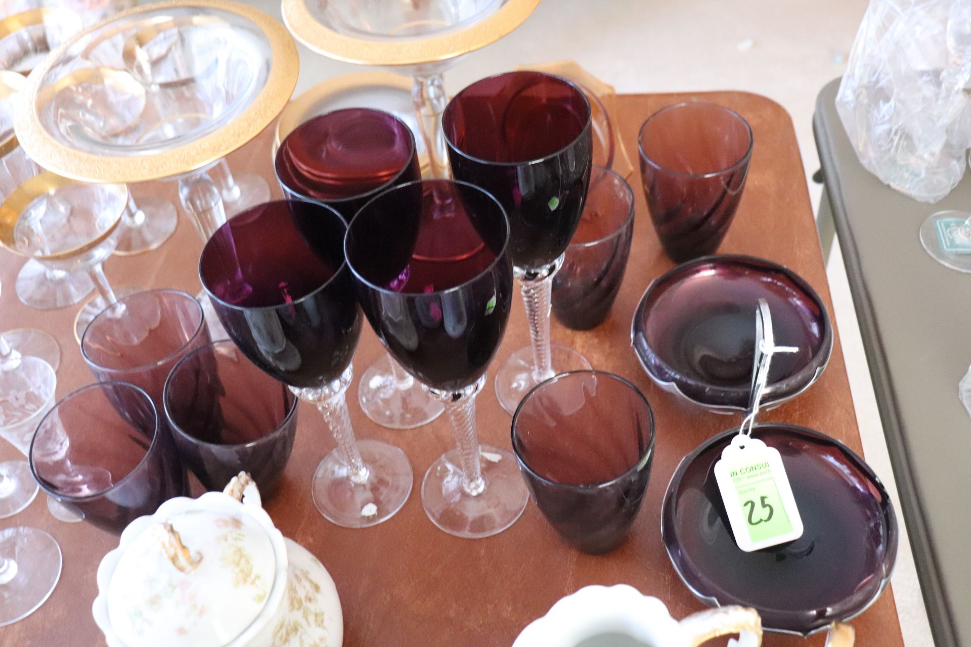 Group of purple wine glasses, cups, and a cracked serving tray