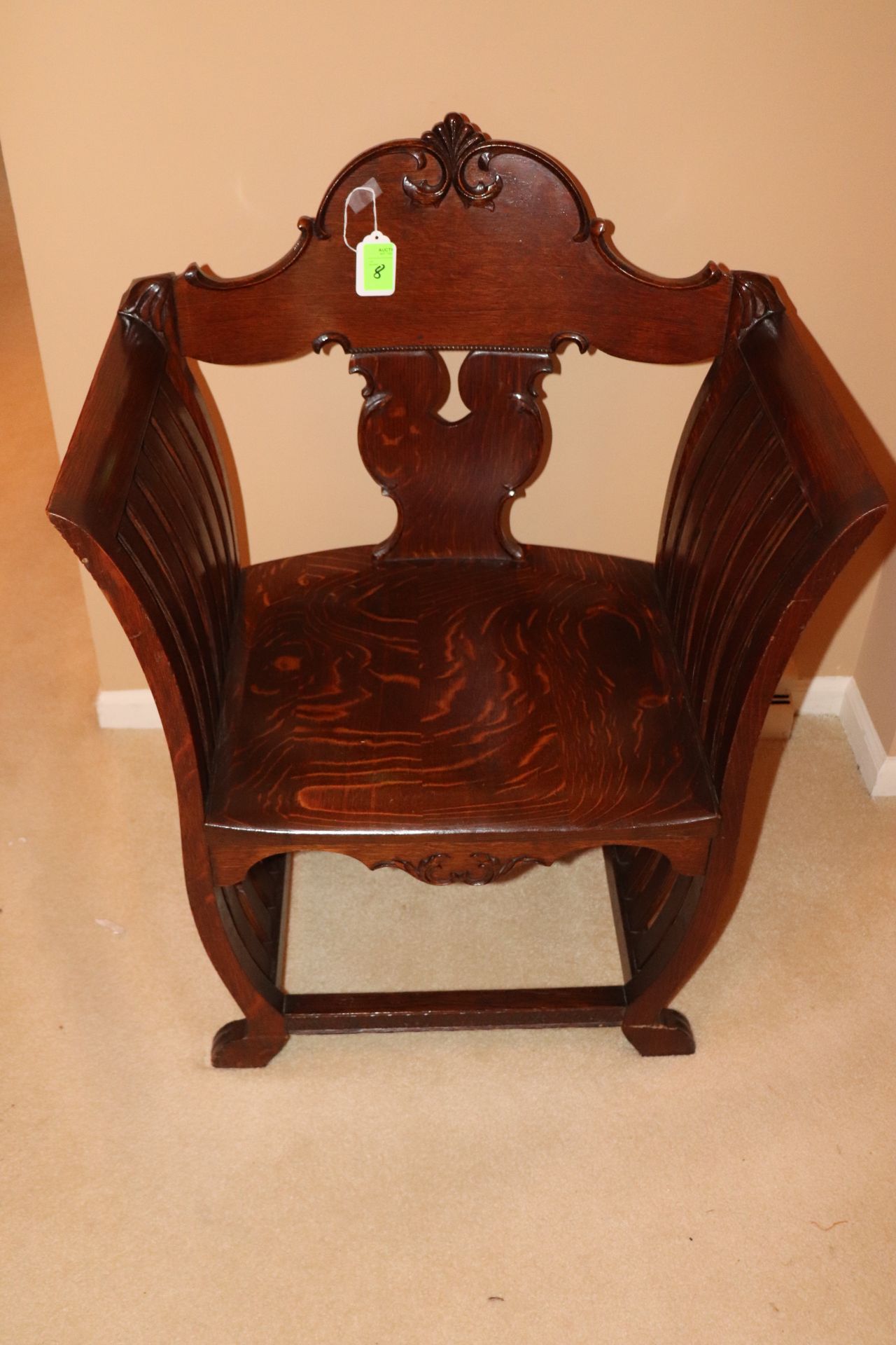 Victorian oak armchair with curved back, flat sides, and carved scrolled leaf decoration, approximat