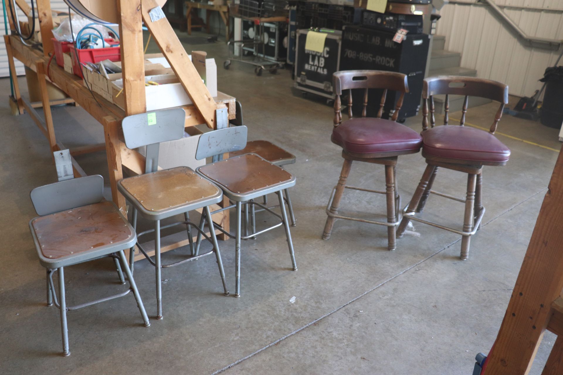 Four metal framed task chairs and two barstools