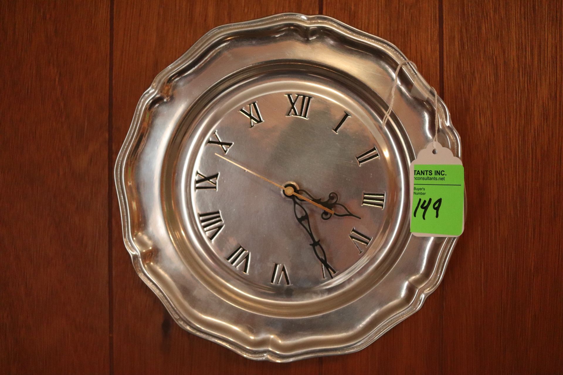 Hanging wall clock with Roman numeral markers, made of metal