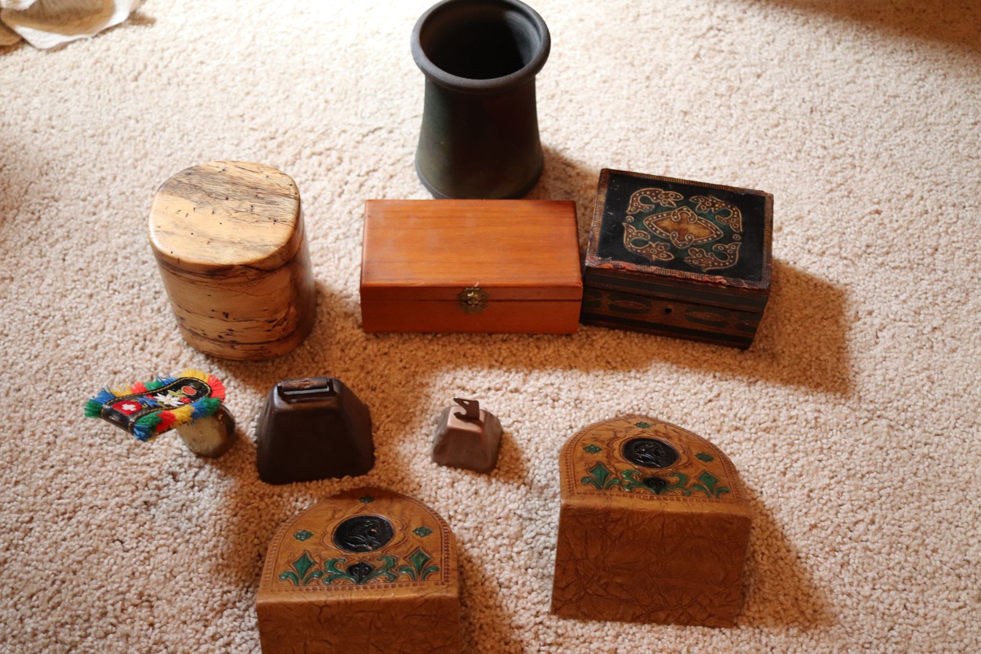 Box lot with curio cases, brass bells, bookends, and a pot