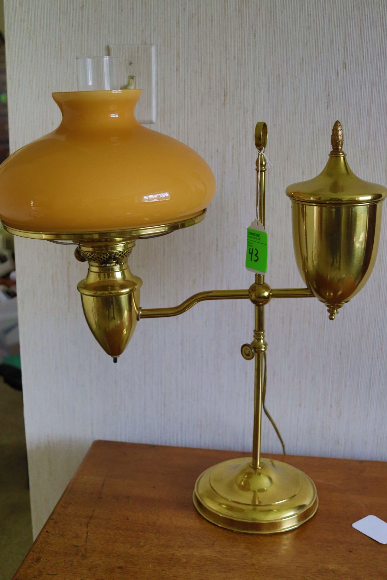 brass candle design table lamp fitted with a beige shade, approximate height 24"