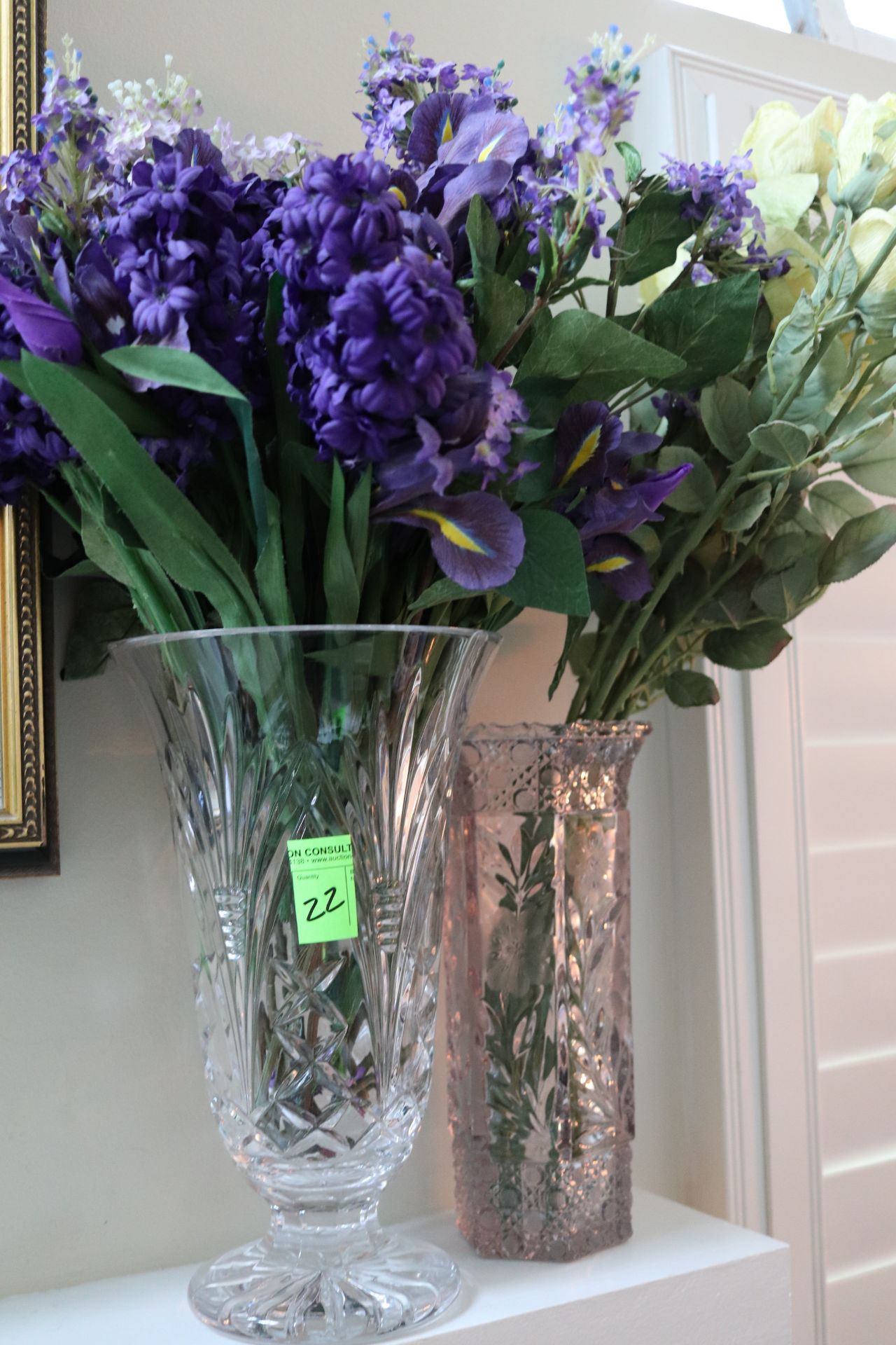 Two pressed and etched glass vases with flowers