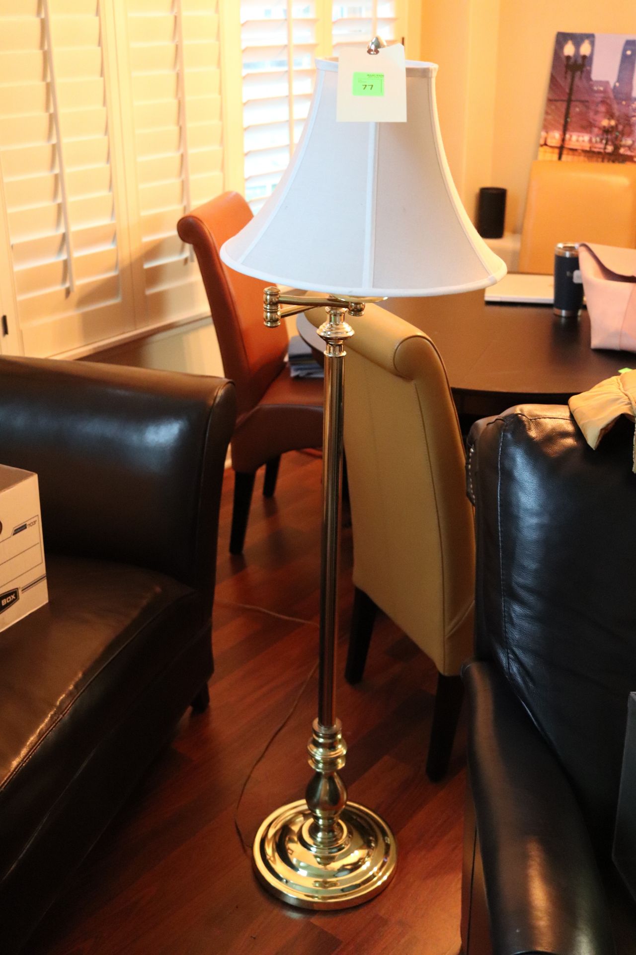 Brass adjustable arm floor lamp fitted with a white shade, approximate height 58"