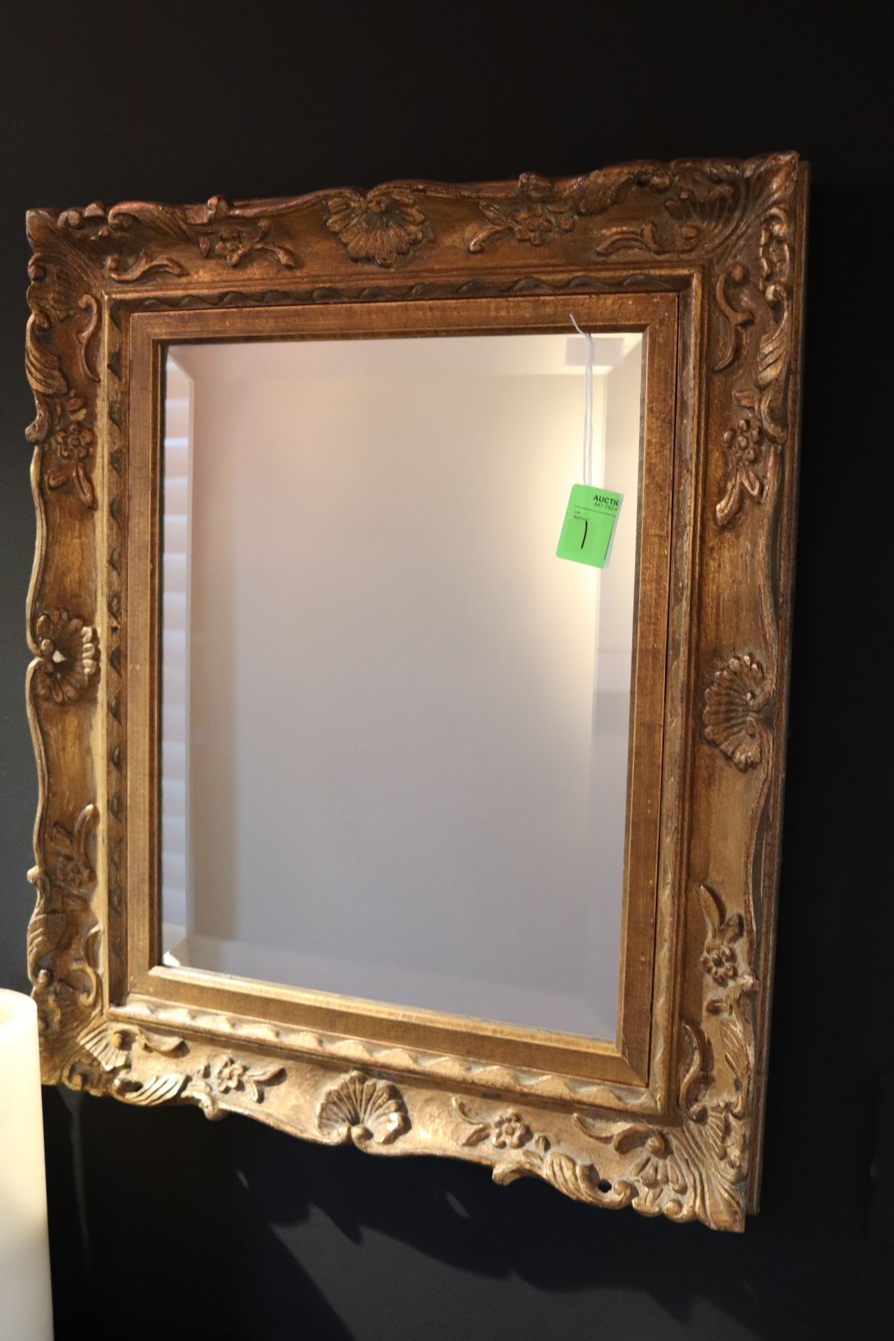 Victorian style gilt framed and beveled glass wall mirror with carved shell, floral and leaf decorat