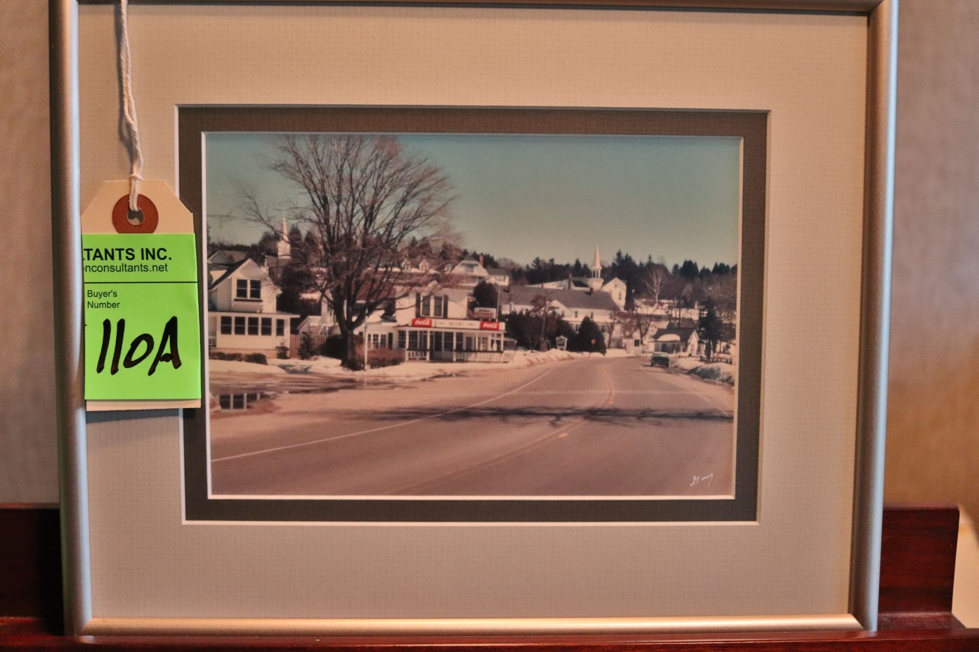 Framed photograph, signed by artist, depicting 1950 small town road, approximate size 8" x 10"