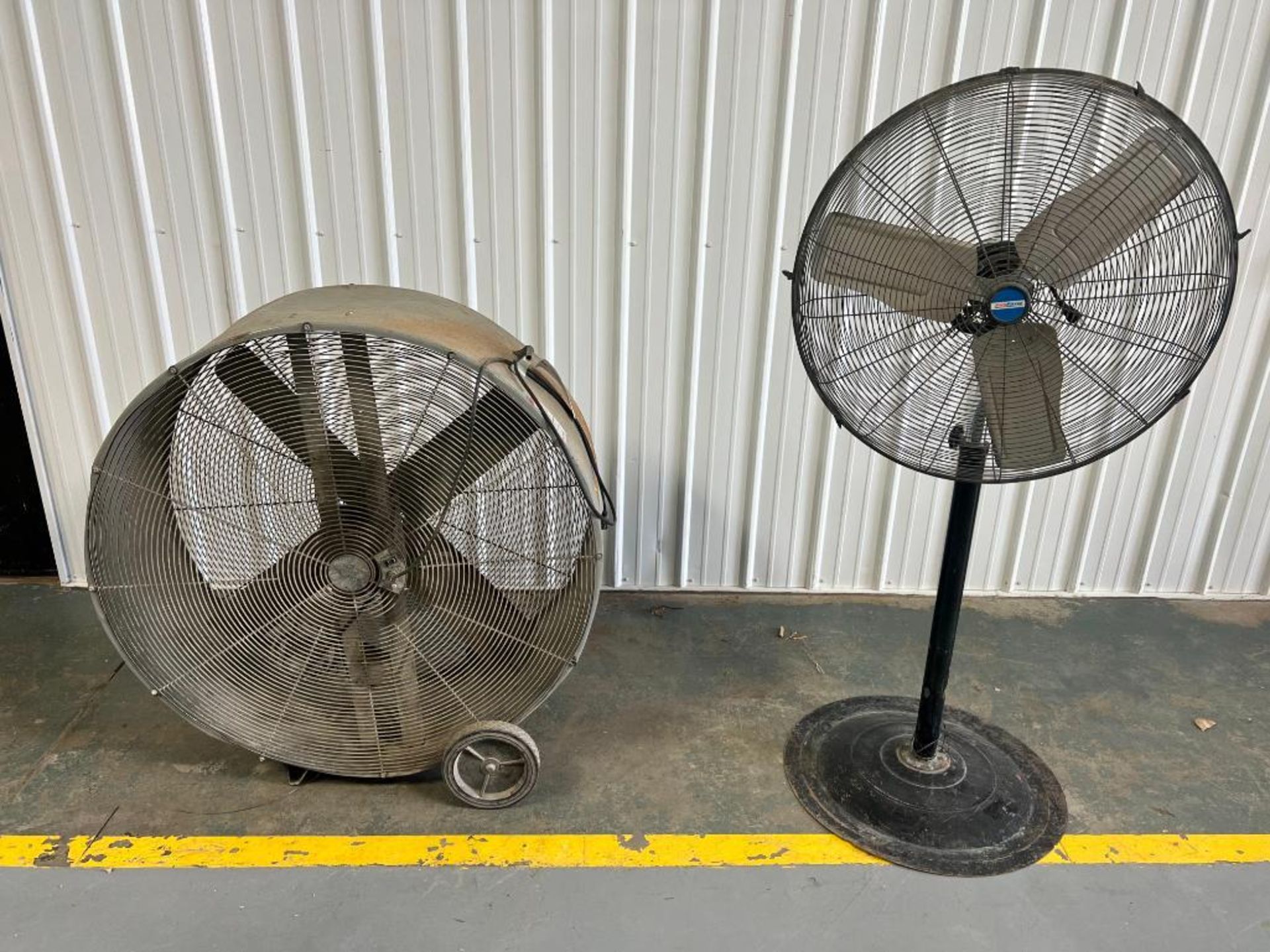 (1) 48" Floor Industrial Fan & (1) 30" Pedestal Industrial Fan. Located in Mt. Pleasant, IA