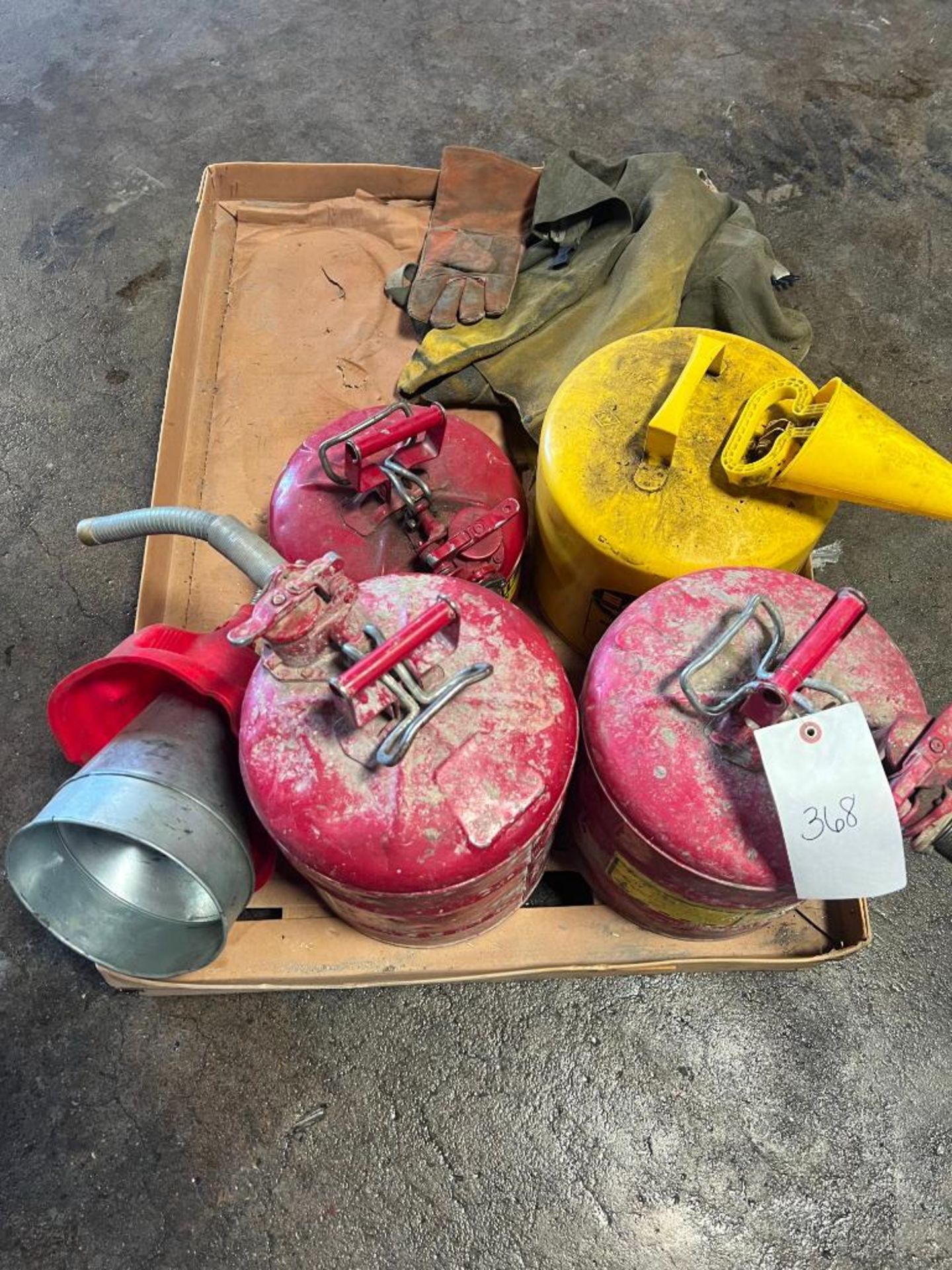 (4) Gas Cans, Funnels & Gloves. Located in Mt. Pleasant, IA