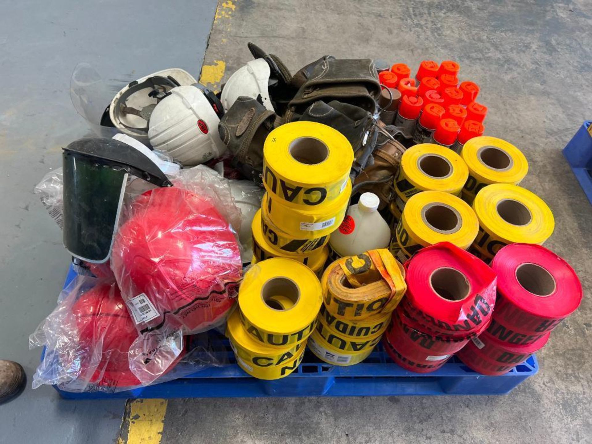 Pallet of Miscellaneous Safety Equipment. New & Used Hard Hats, Caution Tape, Marker Paint, Knee Pad