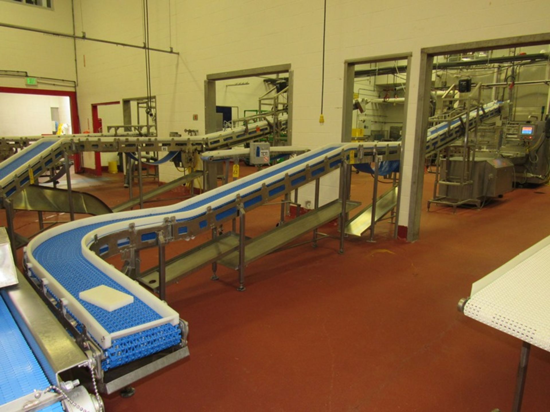 Stainless Steel Incline Conveyor with 90º curve, 12" W X 33' L plastic belt, 27" infeed, 93"
