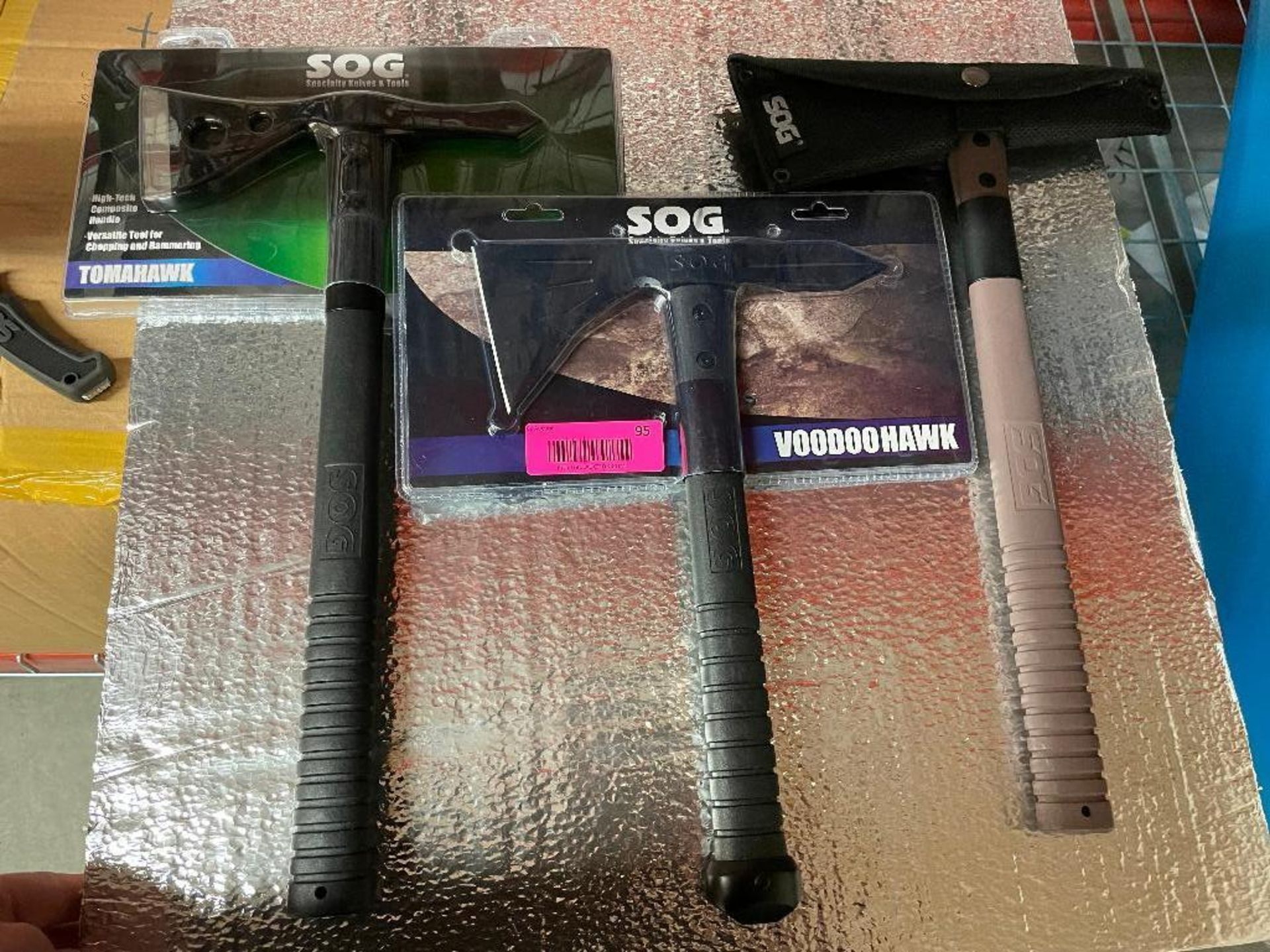 DESCRIPTION: (3) ASSORTED SOG AXES. (2) NEW IN PACKAGING LOCATION: PACKING THIS LOT IS: ONE MONEY QT