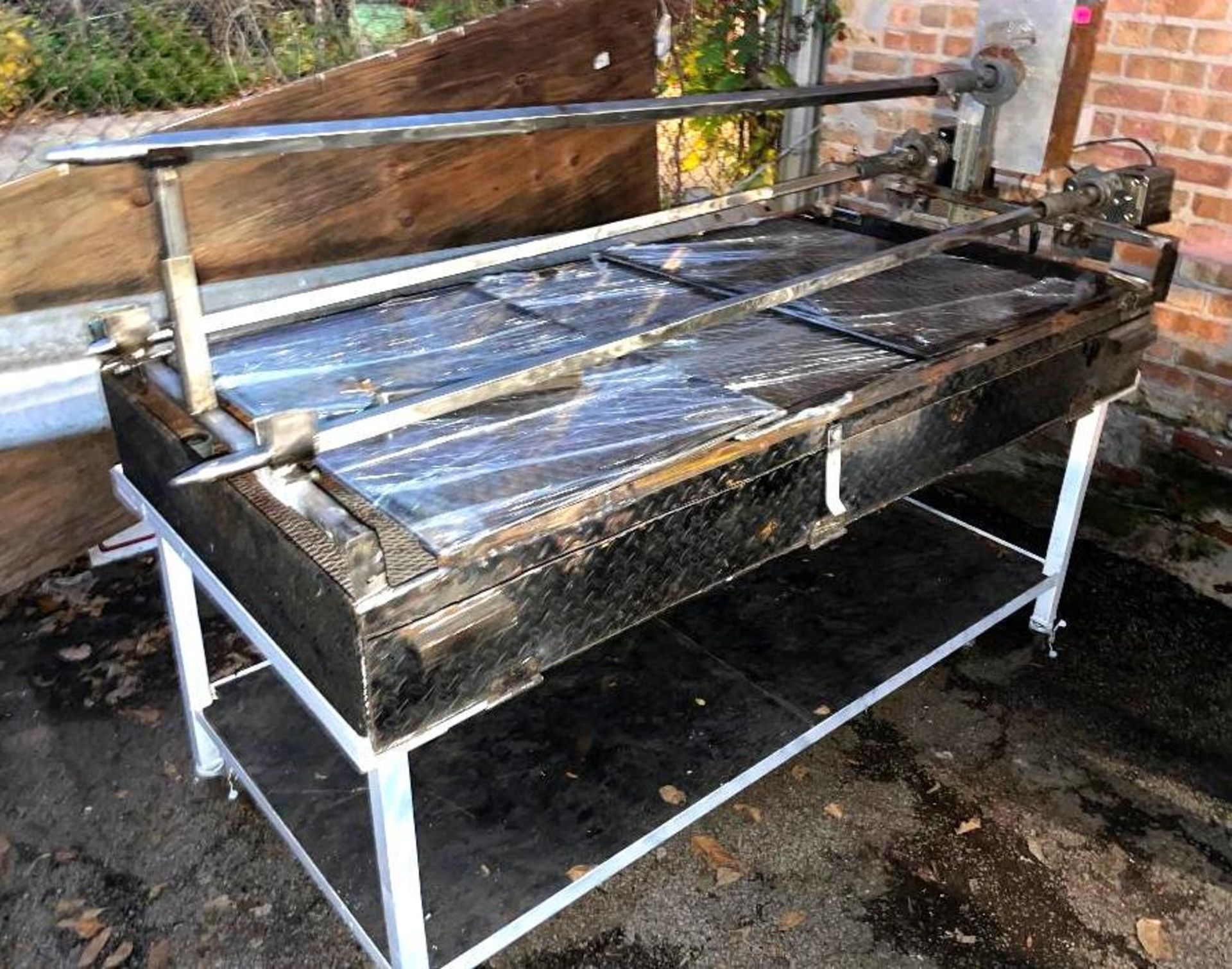 DESCRIPTION: 60" CHARCOAL BBQ GRILL W/ THREE PRONG MOTORIZED ROTISSERIE LOCATION: OUTSIDE QTY: 1