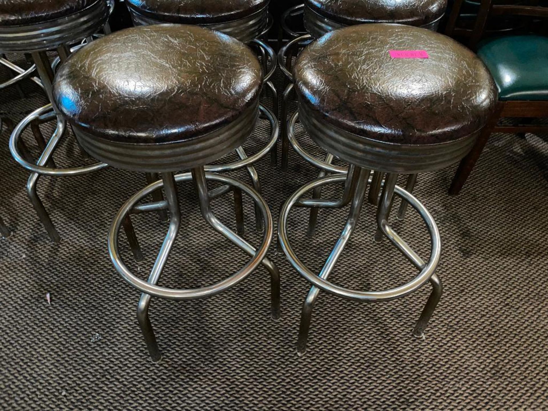 DESCRIPTION: (4) BACKLESS SWIVEL BAR STOOLS W/ CHROME FOOT RAIL. (BROWN) LOCATION: SEATING THIS LOT