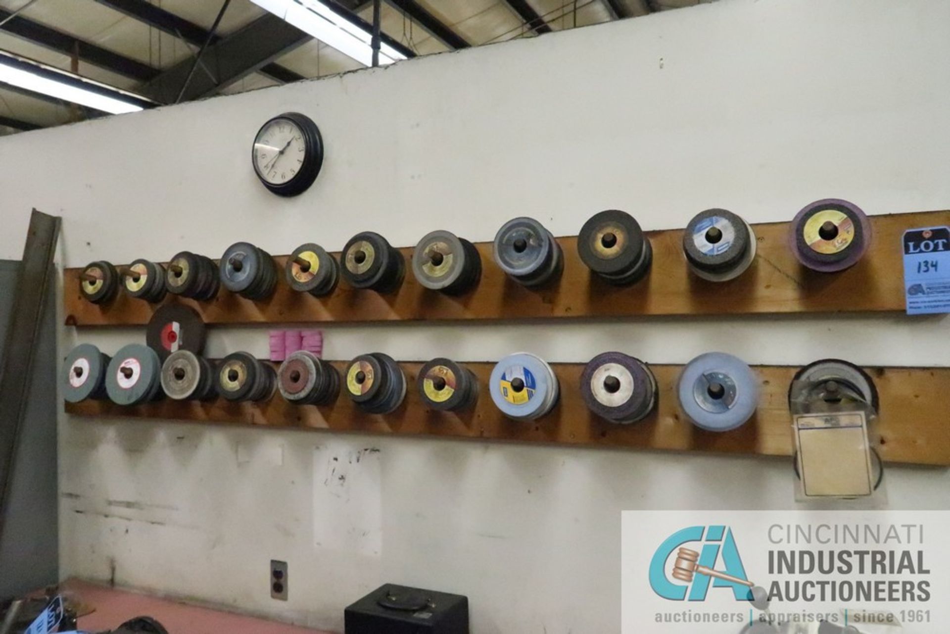 (LOT) MISCELLANEOUS GRINDING WHEELS ON WALL