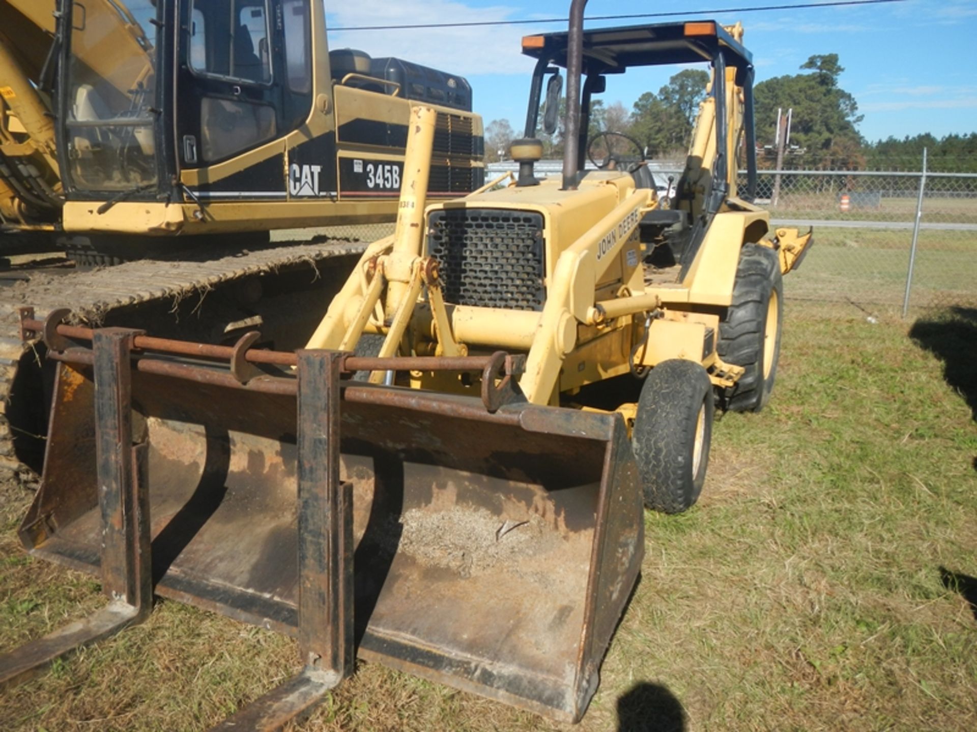 JD 310C backhoe with bucket and forks and 3 rear buckets - 5371 hrs showing - SERIAL: TO310CA743982