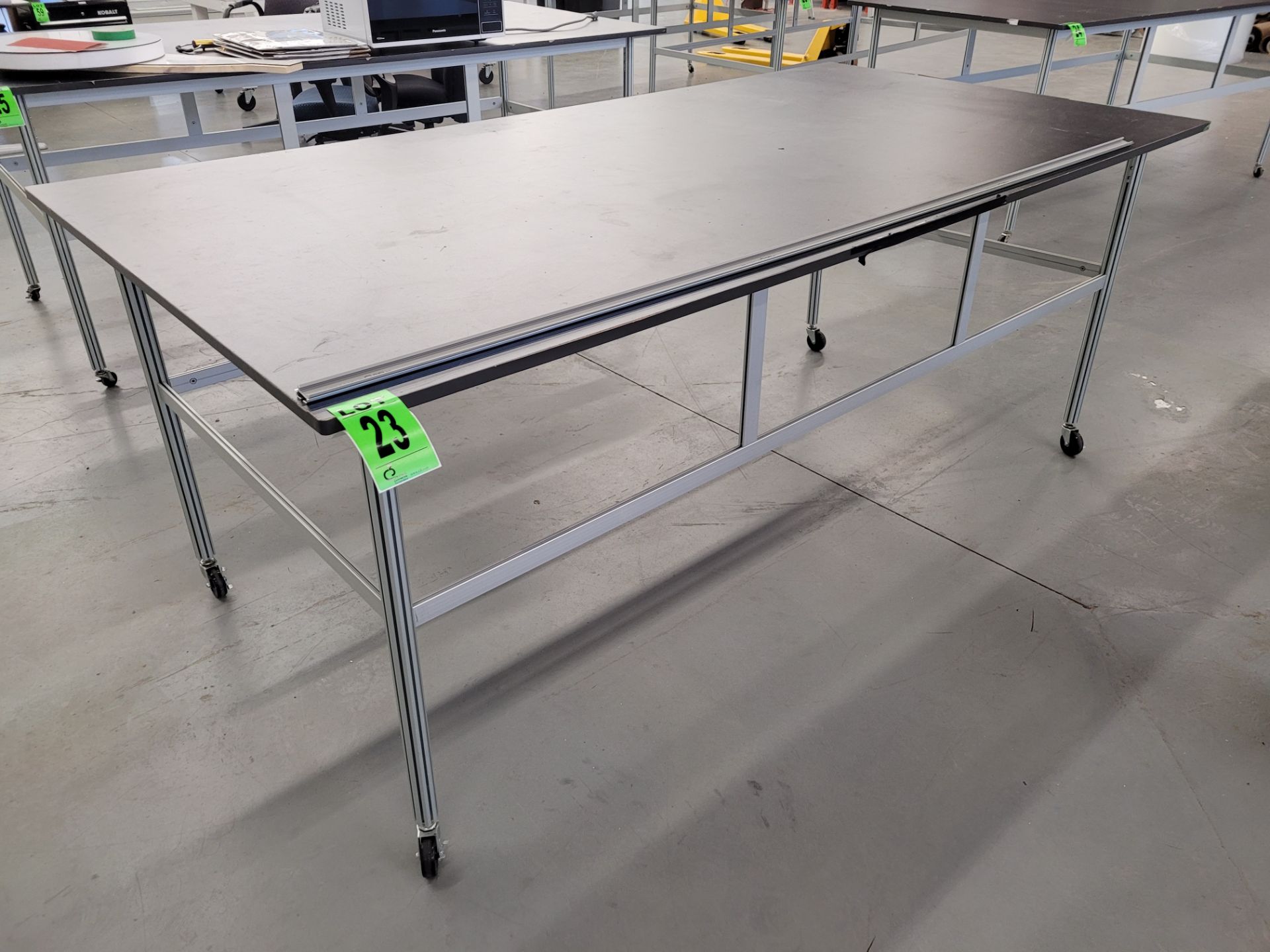 Worktable on aluminum frame, melamine top, on casters, 4' x 8'