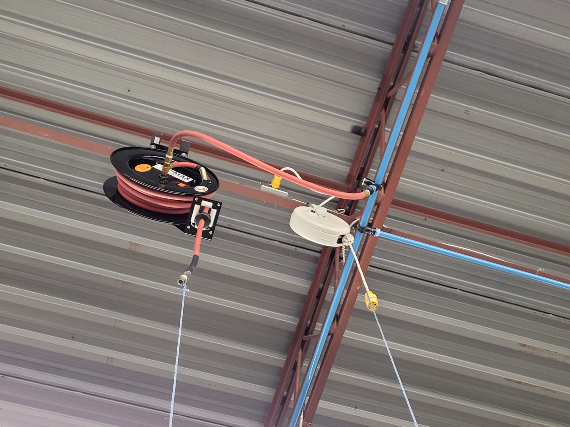 Lot of (1) Air hose and (1) electrical cord reel, mounted on ceiling