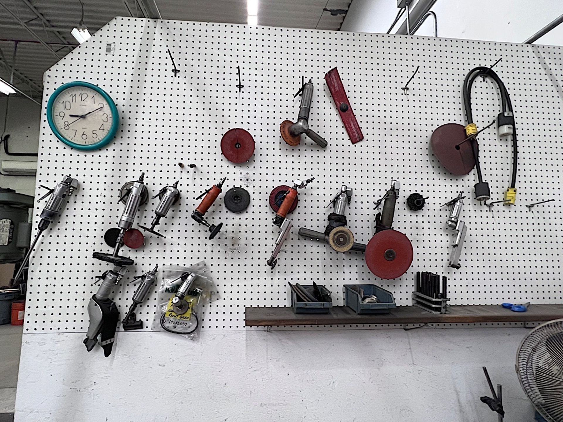 LOT OF PNEUMATIC TOOLS ON WALL