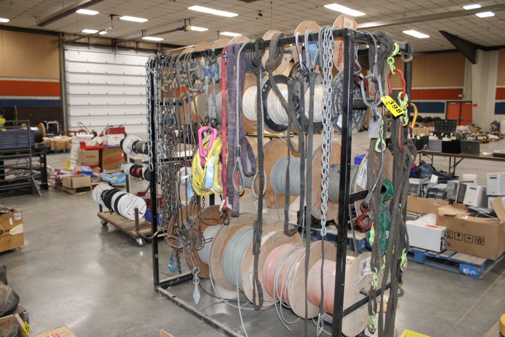 ASSORTED LIFTING CABLES, CHAINS & STRAPS ON RACK (RACK IS NOT INCLUDED)