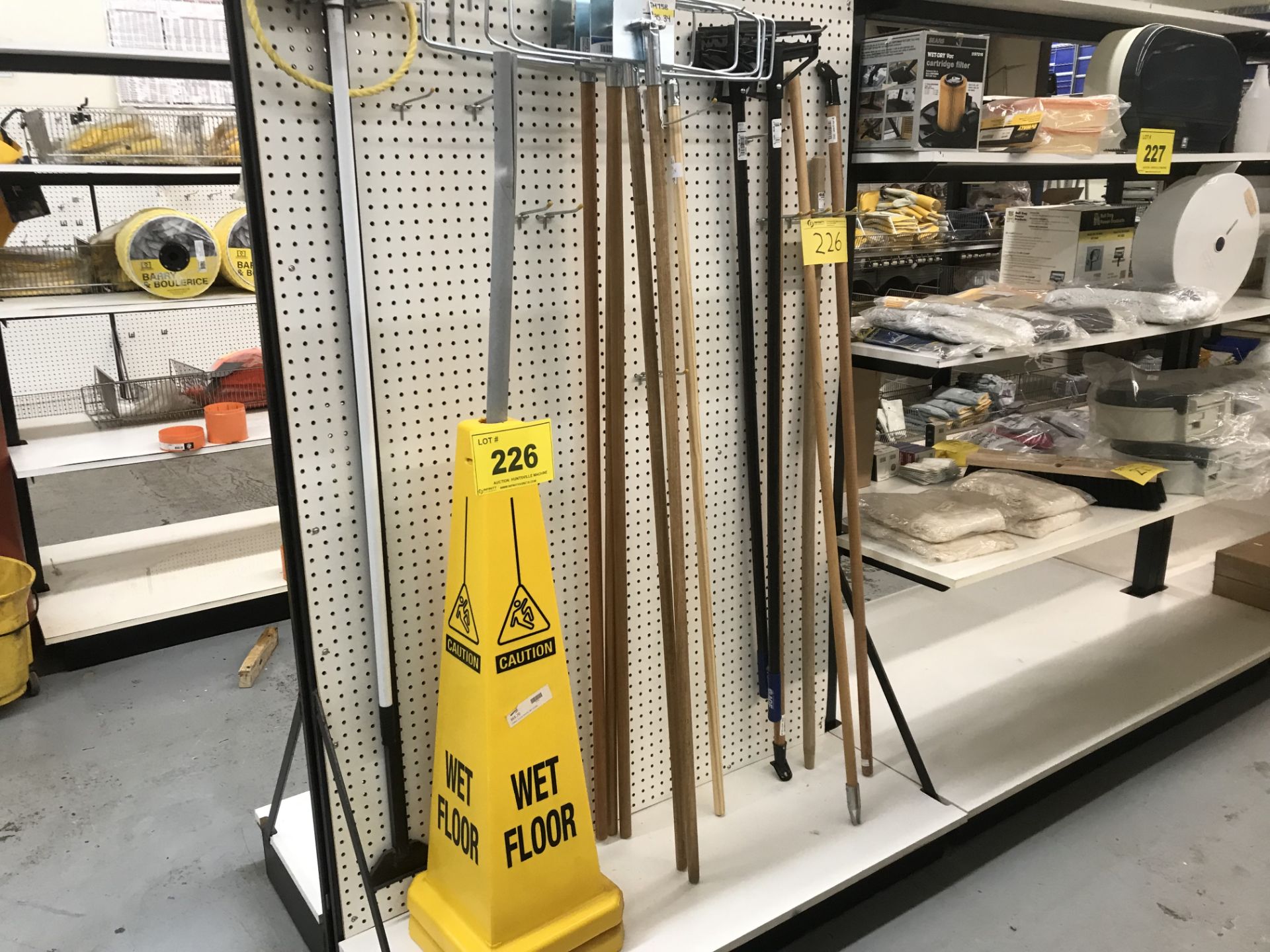 CONTENTS OF (1) SECTION OF DISPLAY RACK INCLUDING SAFETY CONES, MOP AND BROOM HANDLES (RACK NOT