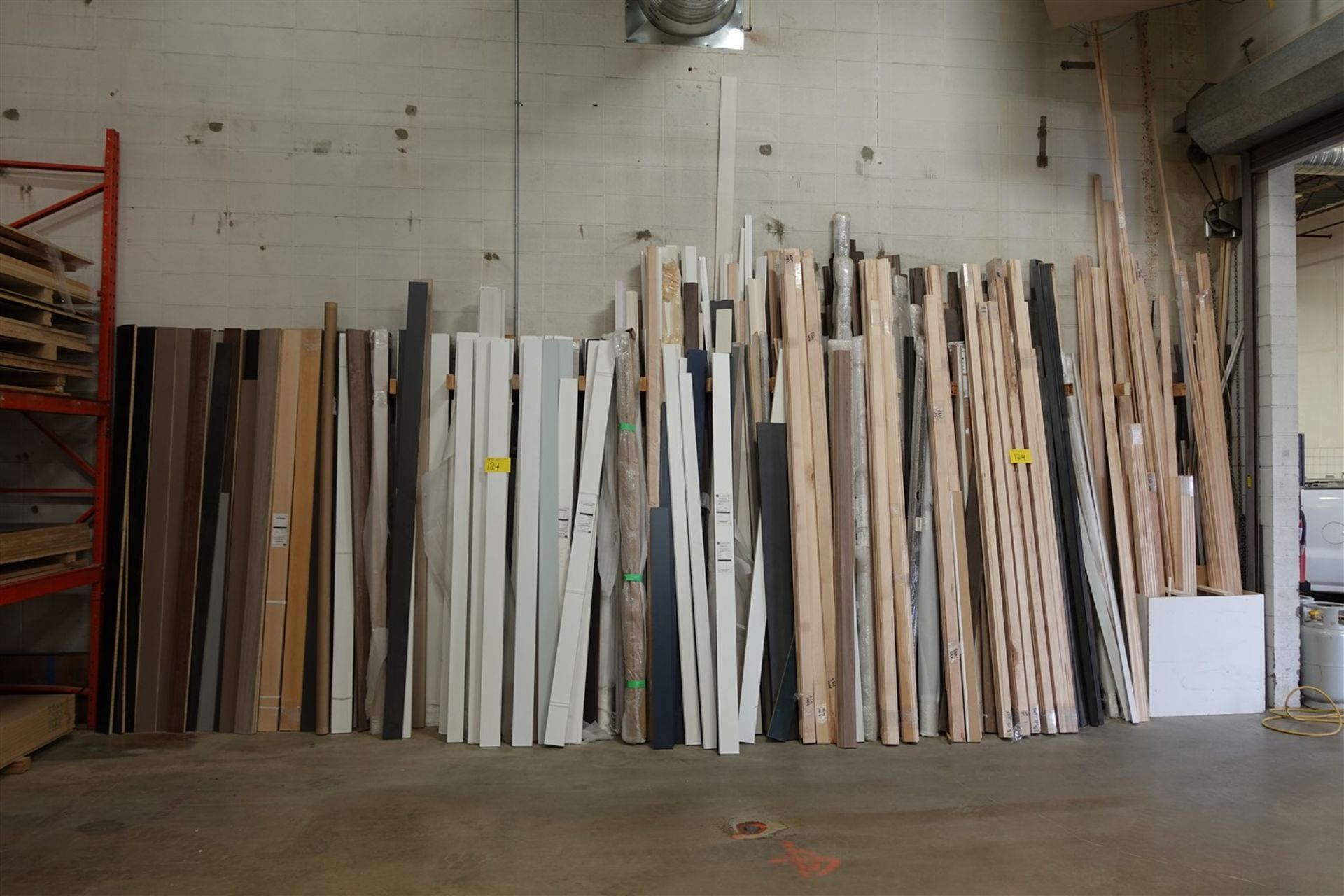 LOT OF ASSORTED BASE BOARDS, MOLDED PANELS ETC. AGAINST WALL