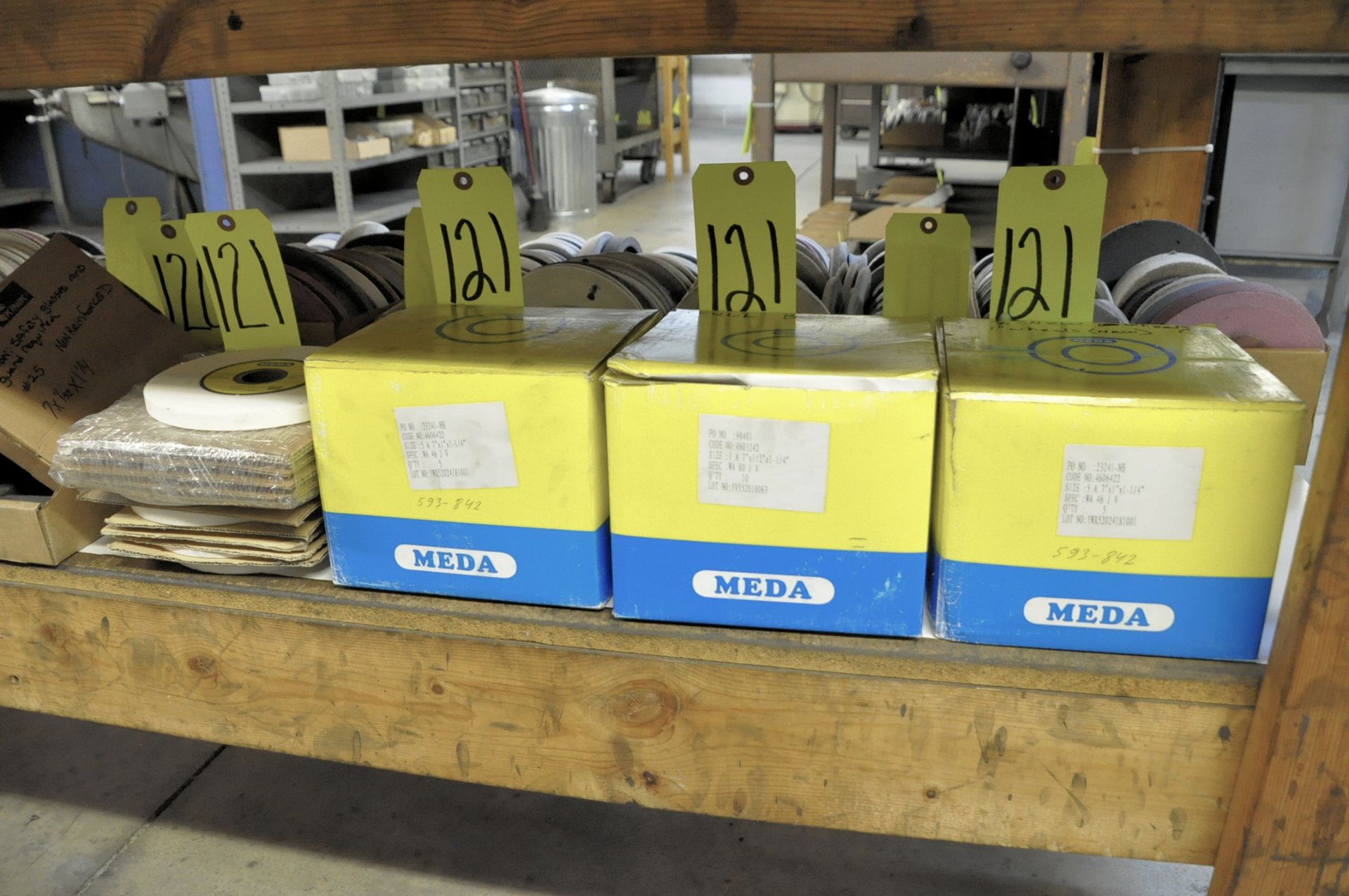 Lot-Packaged Grinding Wheels in (3) Boxes and (1) Stack Under (1) Bench