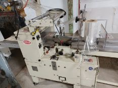 Doboy Scotty flow wrapper in running condition former foods use. SS carier chain with pushers every