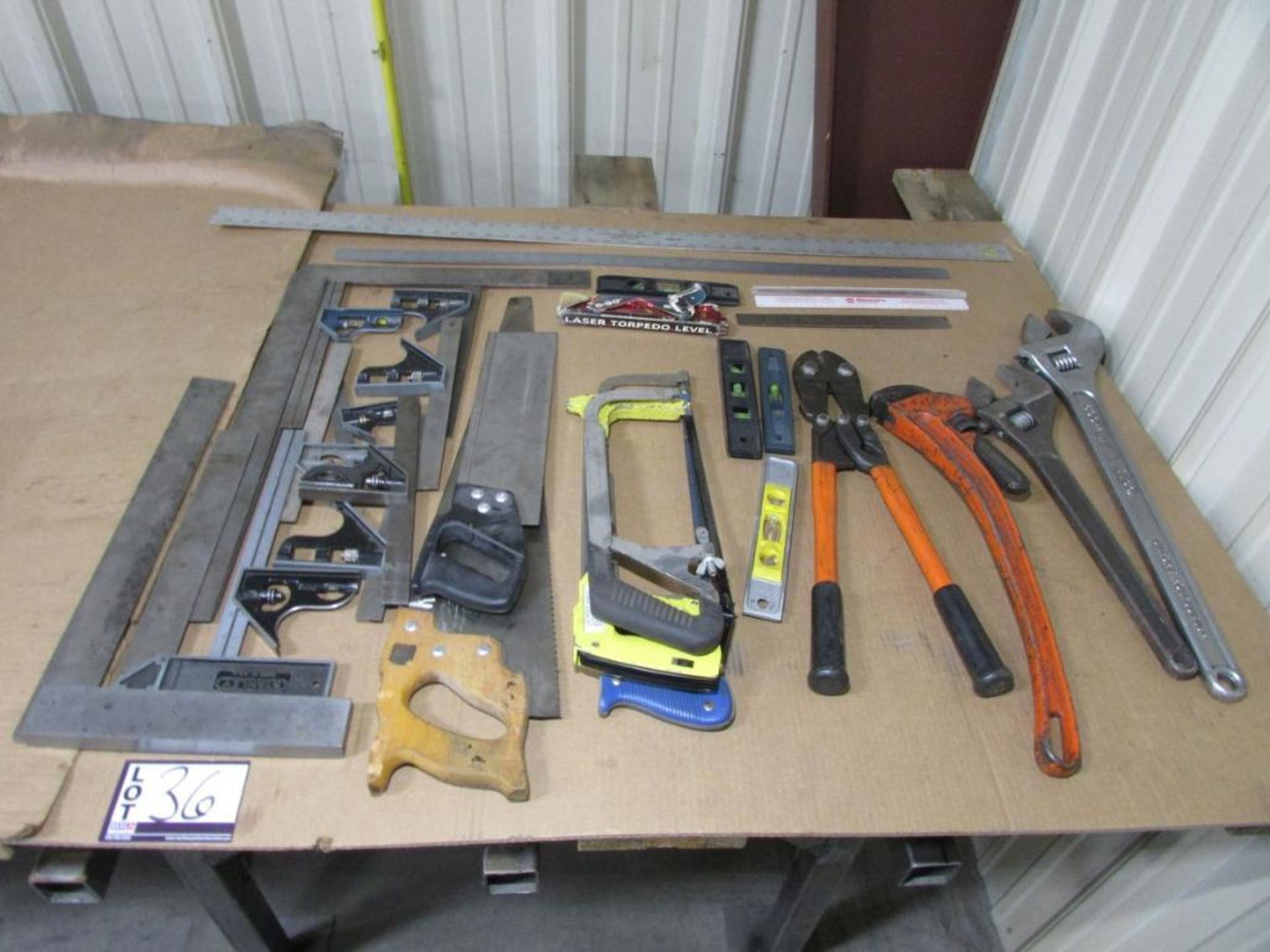 Assorted Hand Tools: Ruler, leveler, Squares, Saws, Compression tool, Adjustable Wrenches, and Pipe