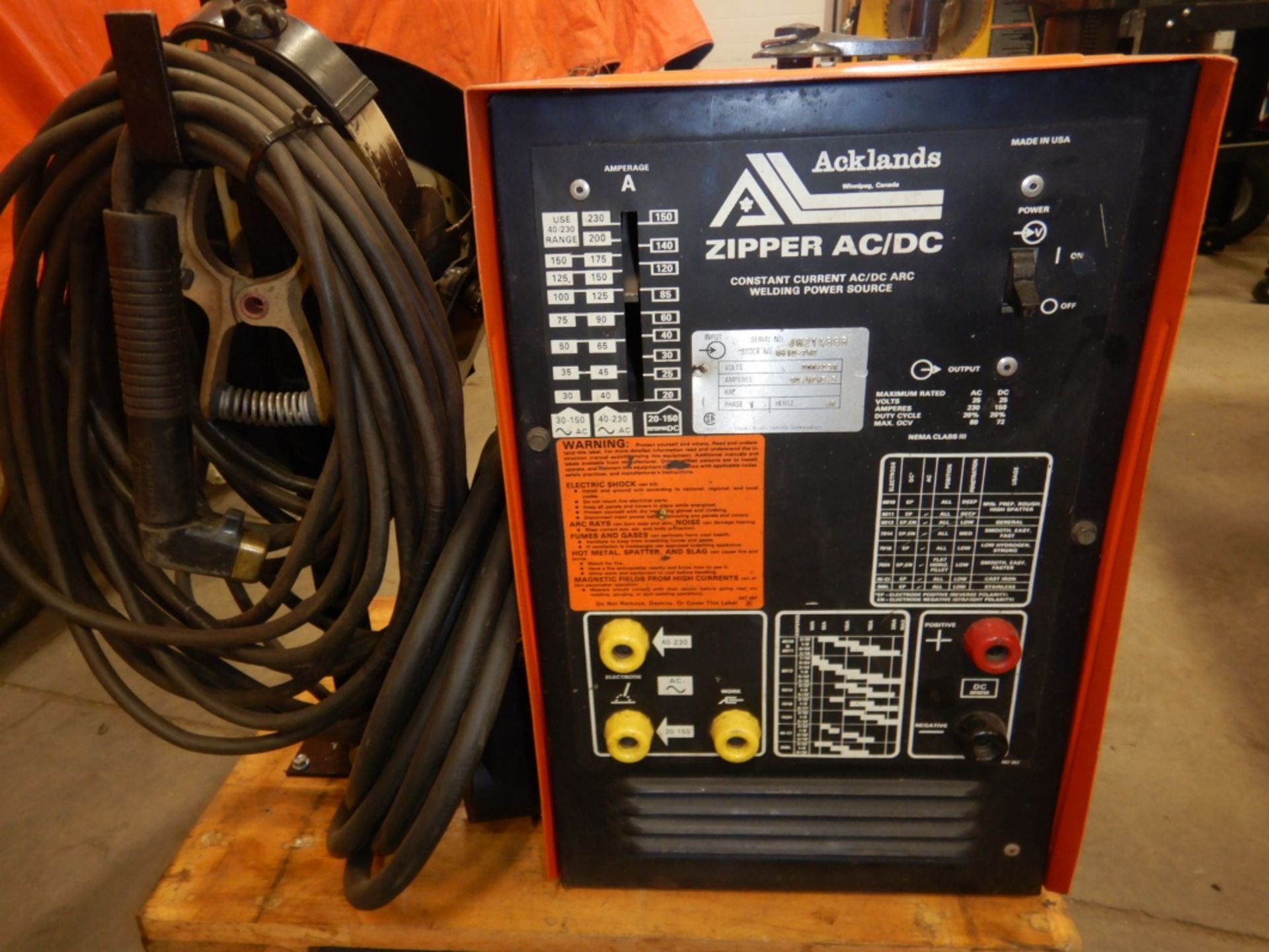 ACKLANDS AC/DC ARC WELDER ON A BASE W/ HELMET AND CORDS