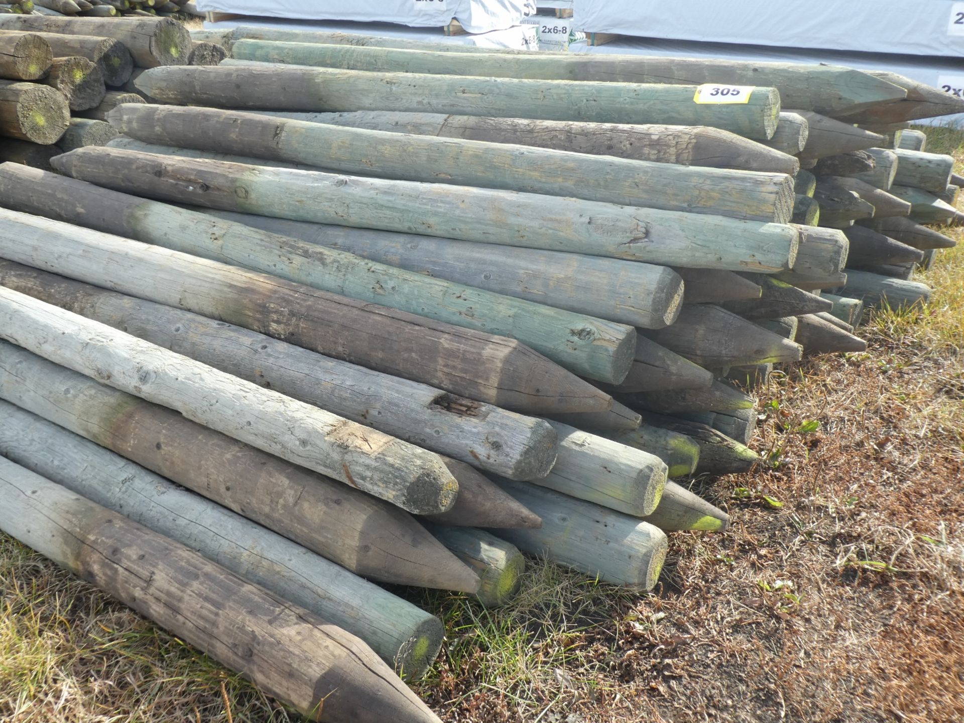 63-7FT 4-5IN TREATED FENCE POSTS