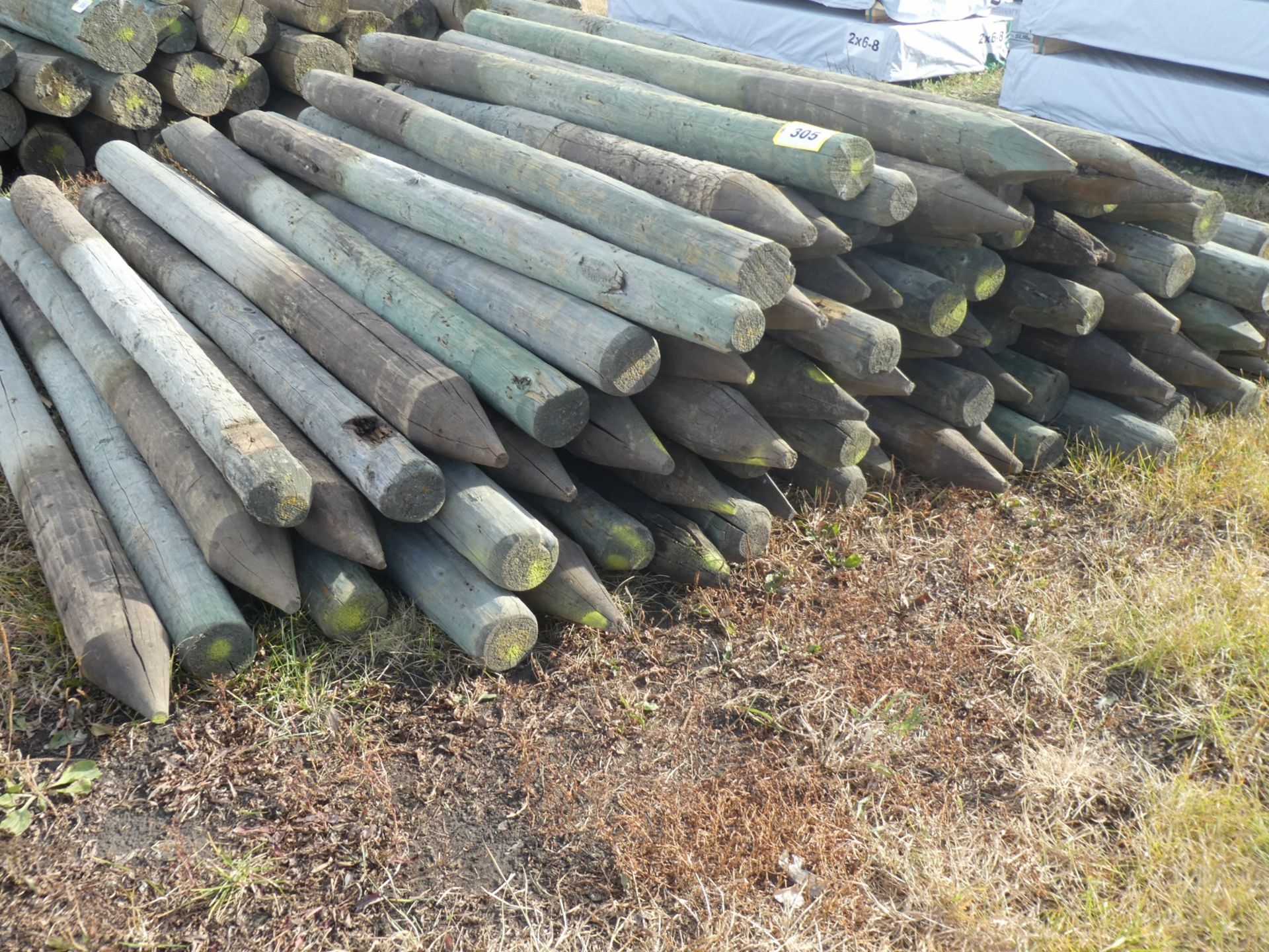 63-7FT 4-5IN TREATED FENCE POSTS - Image 2 of 2