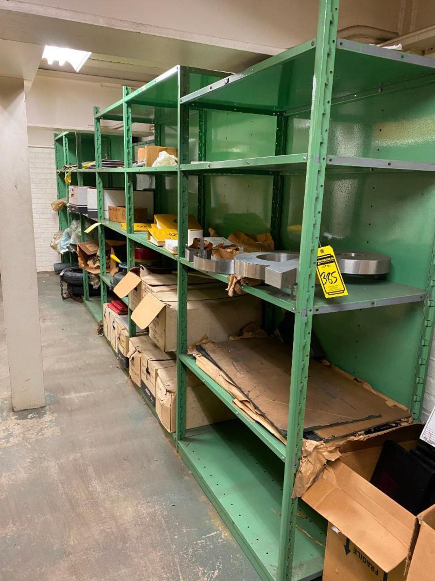 CONTENT OF ROOM: (8) SECTIONS OF SHELVING, TIRES, STENCIL MACHINE, WOODEN CRATES, CORK BOARD