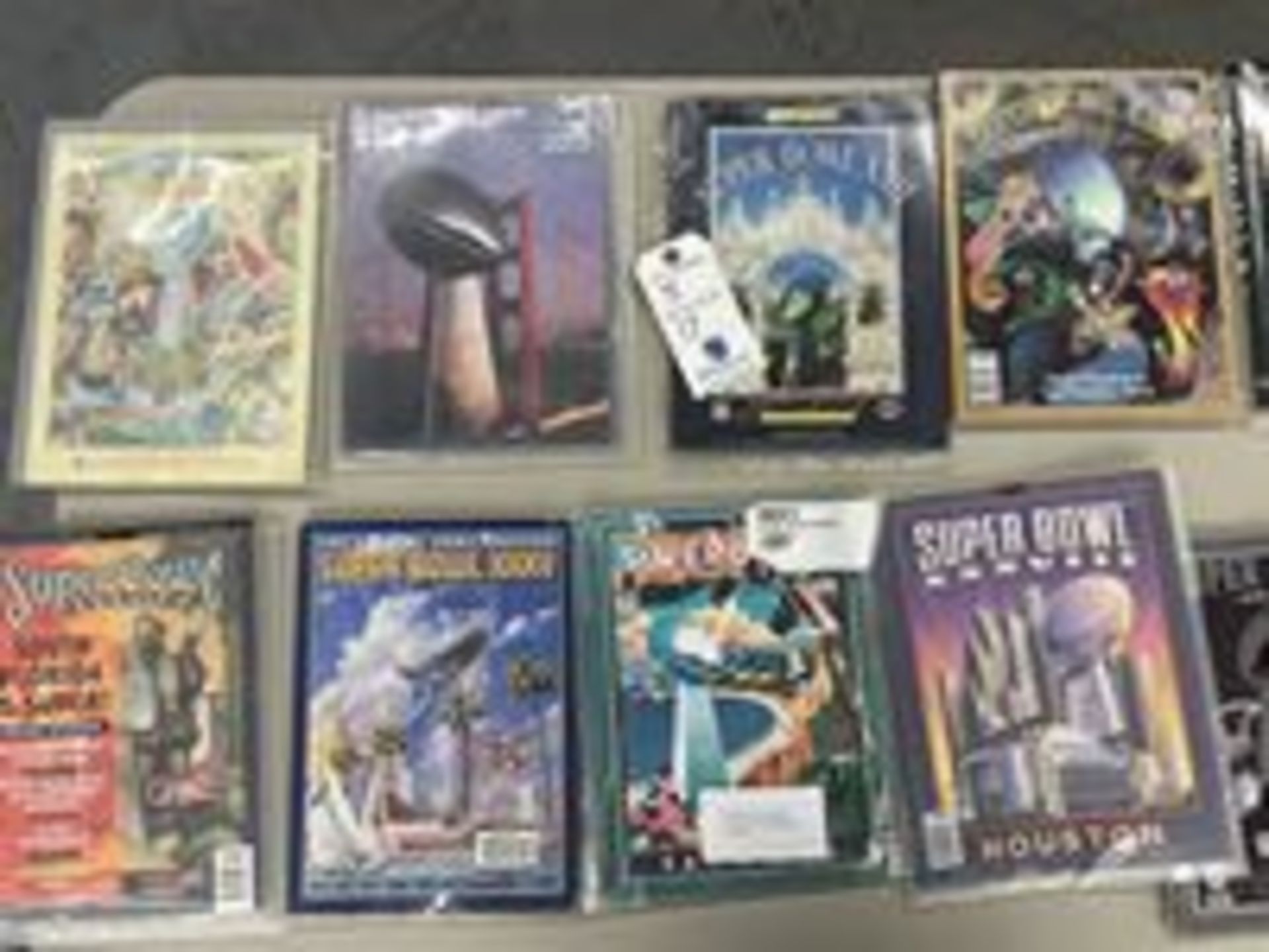 (Lot) (17) Official Super Bowl Programs in cases, 1984, 1985, 1988, 1990, 1994, 1995, 1996, 1997,