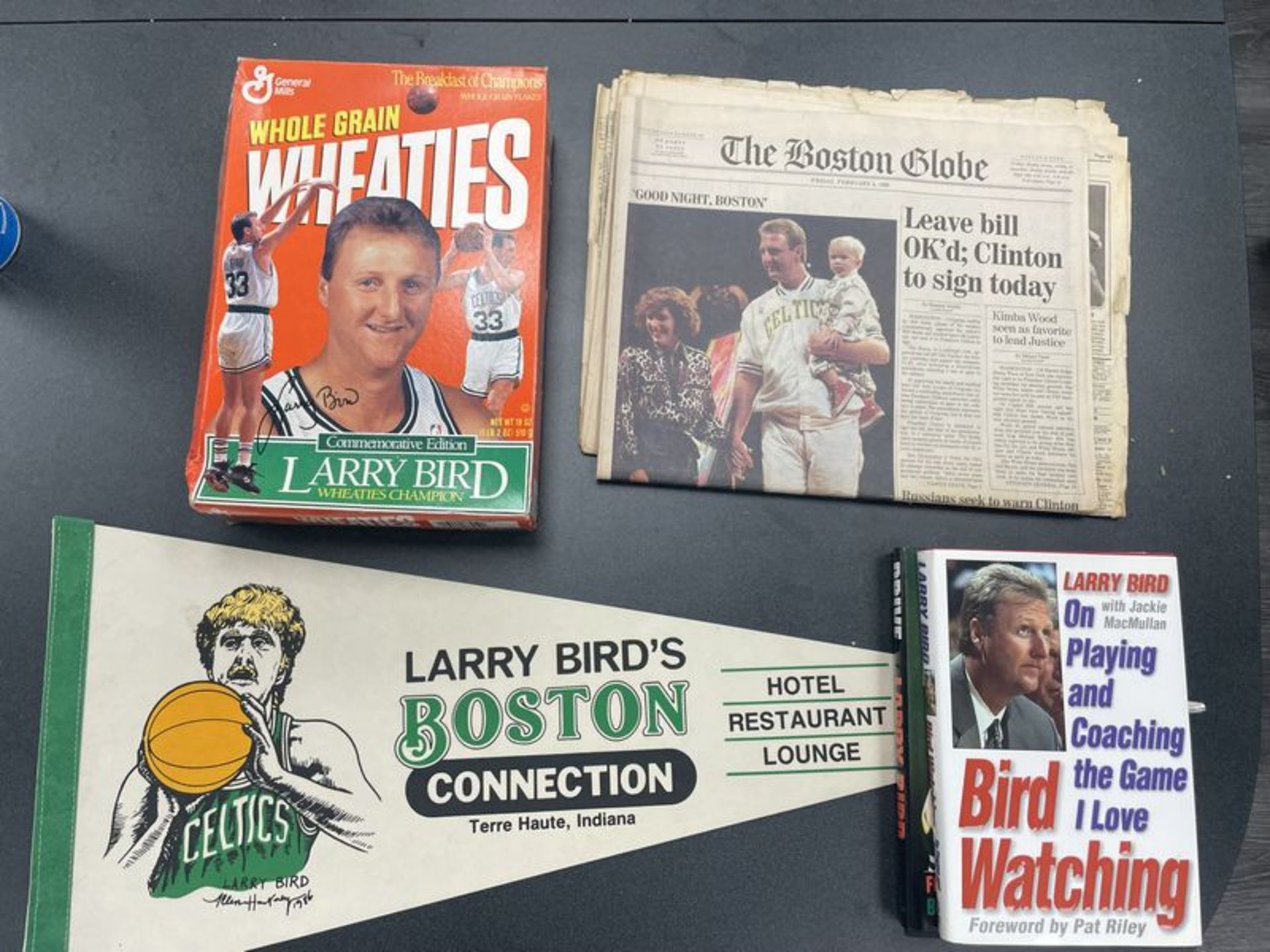 (Lot) Larry Bird c/o: Wheaties Box tape on box , Boston Connection Pennant, International Herald