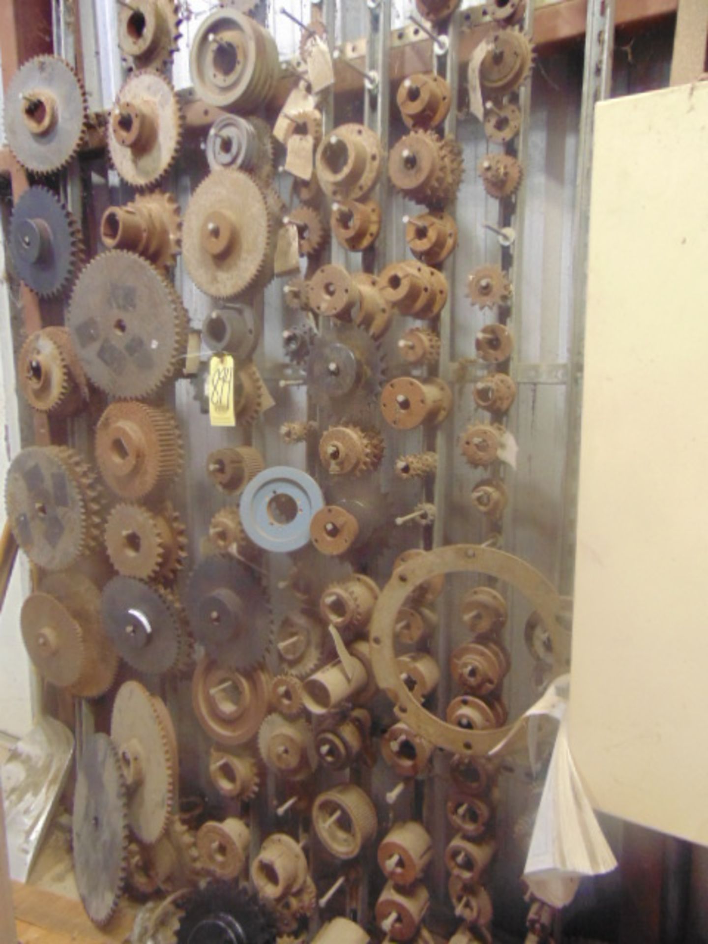 LOT OF SPROCKETS & GEARS, assorted, on wall (Located in bldg. 8)