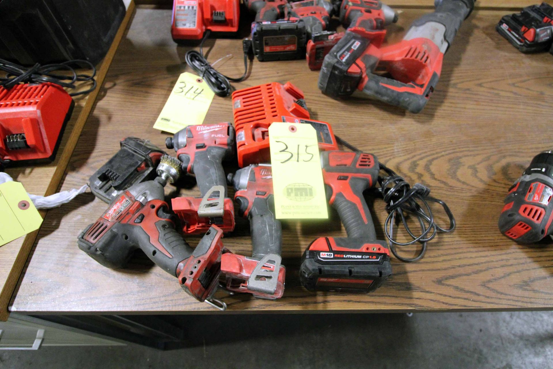 LOT OF MILWAUKEE CORDLESS TOOLING: (4) impact drills, (2) batteries & (1) charger
