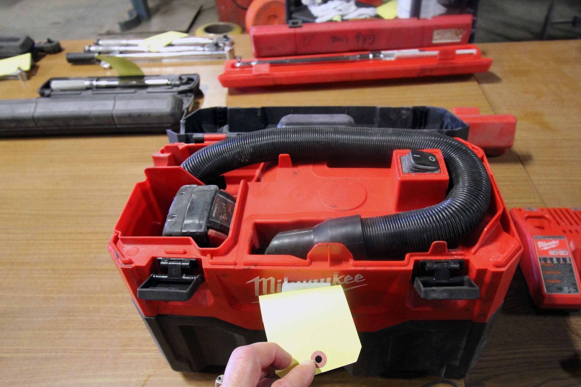 LOT OF MILWAUKEE CORDLESS TOOLING: (1) vacuum, (1) transfer pump, (1) charger & (2) batteries
