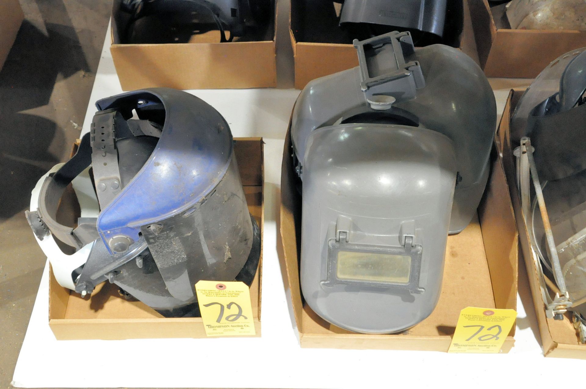 Lot-Welding Helmets in (4) Boxes Under (1) Table