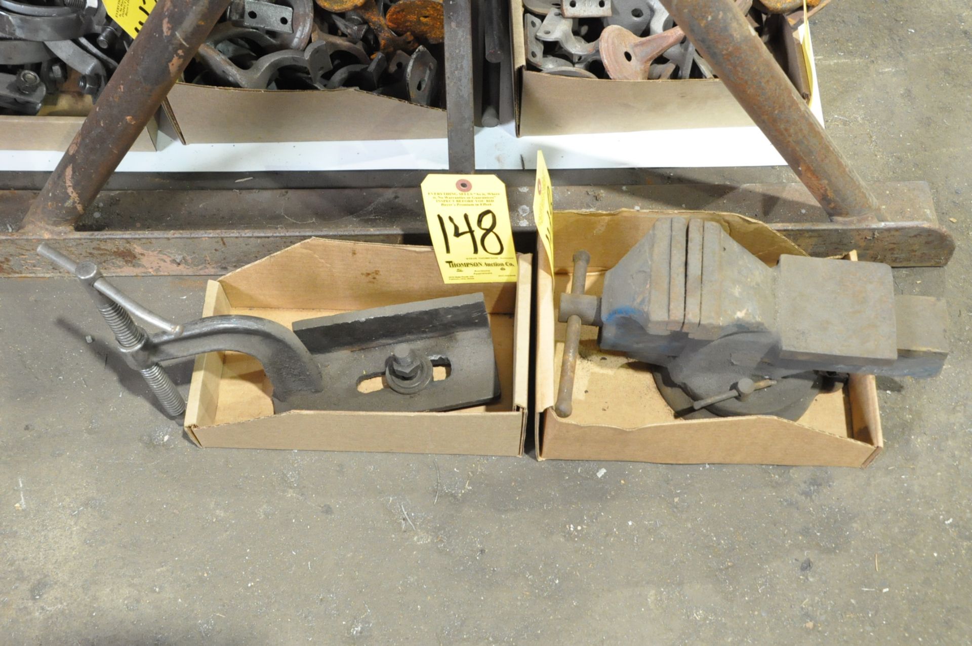 Lot-(1) 4" Swivel Bench Vise and (1) Clamp Fixture in (2) Boxes on Floor Under (1) Table