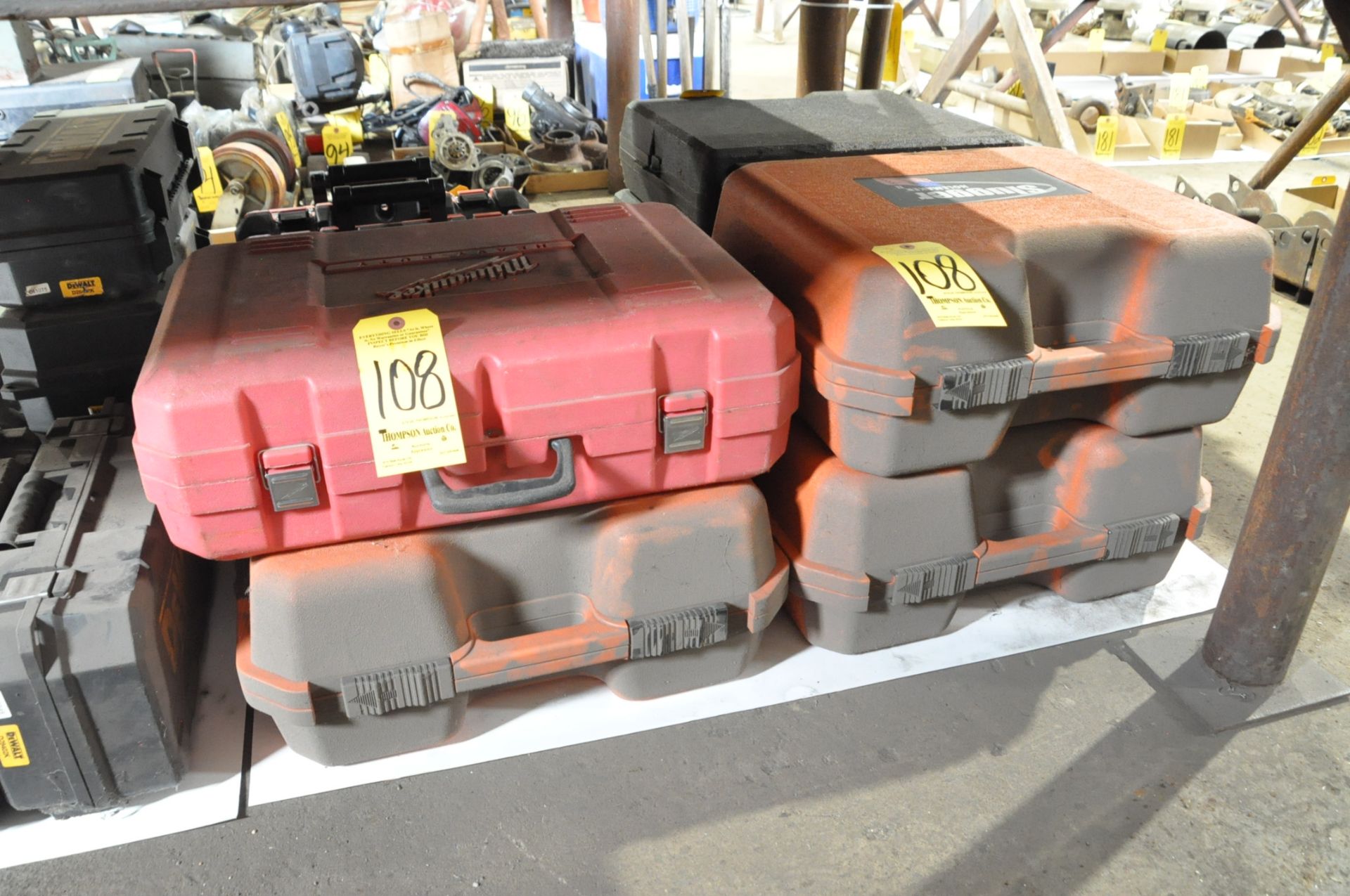 Lot-(3) Empty Slugger and (1) Milwaukee Plastic Power Tool Cases on Floor Under (1) Table