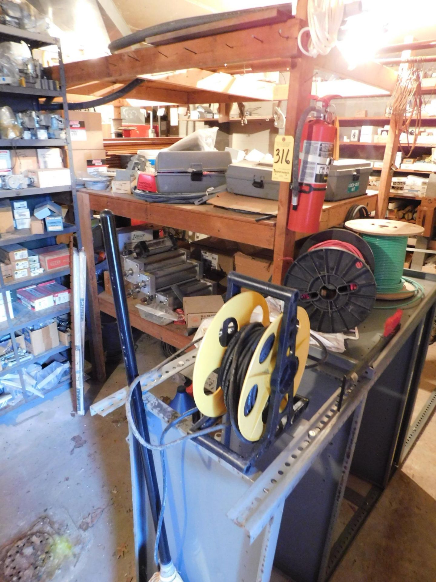 Contents of Wood Shelving in Middle of Room, Pneumatic Cylinders, Lock out Kits, Wire, Conduit