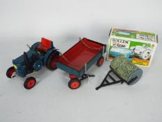 Kovap - A vintage clockwork presses steel tractor and drawbar trailer with chains and opening