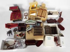 A collection of dolls house furniture and effects in mainly wood, leather,