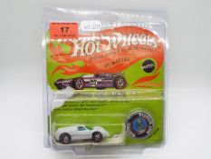 Hot Wheels - Redline - An original unopened carded Ford J-Car model in Enamel White.