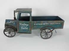 A large decorative tinplate truck measur