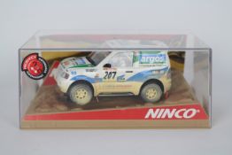 Ninco - A boxed Mitsubishi Pajero Montero Rally car in Argos livery # 50323.