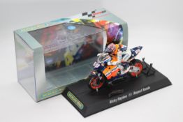Scalextric - A boxed 2004 Moto GP Repsol Honda ridden by Nicky Hayden # C6016 The model appears