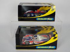 Scalextric - Two boxed Scalextric 1:32 scale MG Lola slot cars. Lot consists Scalextric .
