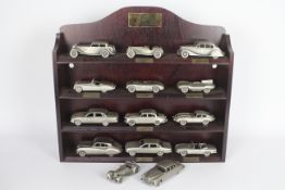 Danbury Mint - A boxed collection of 12 Danbury Mint Jaguar 1:43 scale pewter cars with wooden