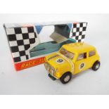 Scalextric - A vintage 1970s C-7 Mini Cooper in yellow in a reproduction box.